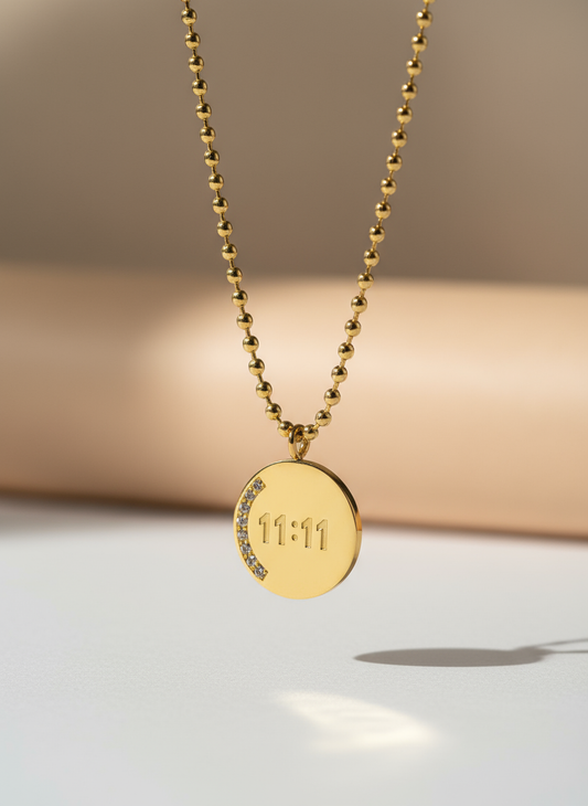 Gold plated 11:11 pendant necklace with crystal detailing on round charm.