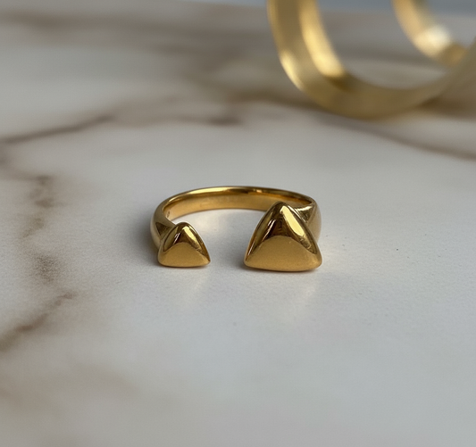 Gold open ring featuring twin pyramid studs on each end with polished finish.