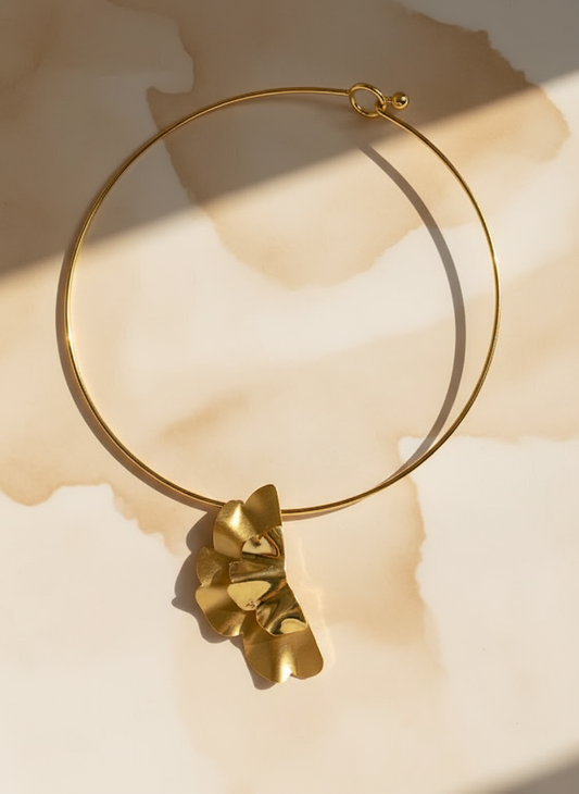 Minimalist gold choker featuring a wavy sculpted pendant with matte and polished finish.